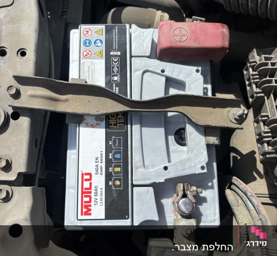 מצבר רכב מותקן בתא מנוע עם חיבורים חשמליים